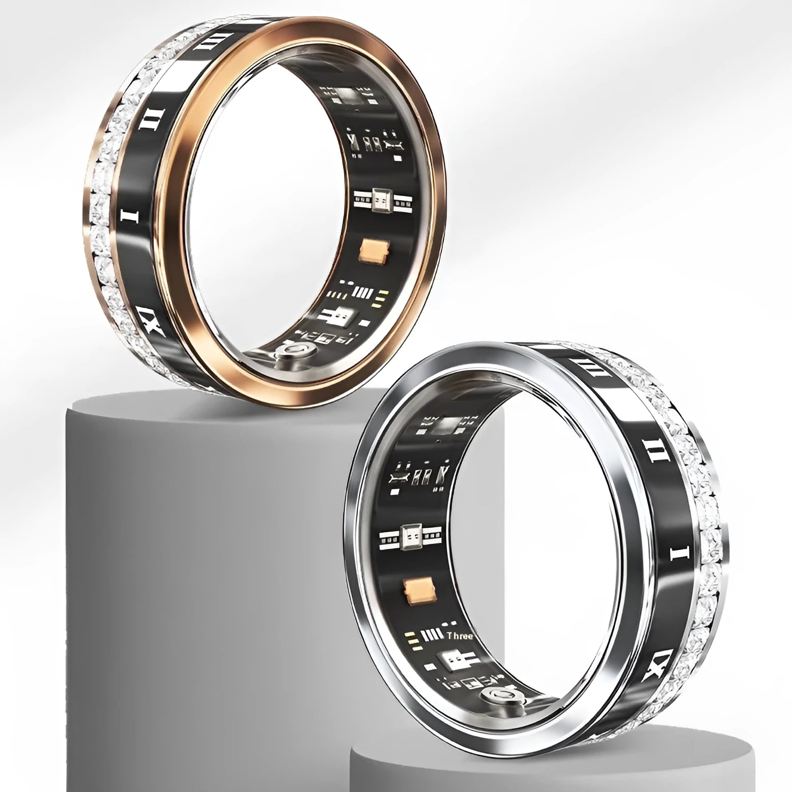 Silver and gold smart rings with blood oxygen monitoring feature on display with charging cable