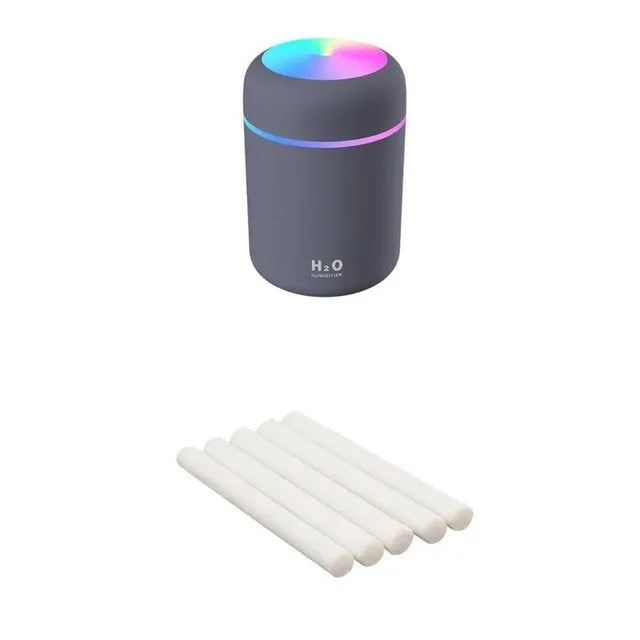 Pink USB desktop humidifier with colourful LED lights and 300ml water tank on wooden desk