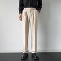 Men's apricot and black straight-leg loose fit suit trousers on a hanger
