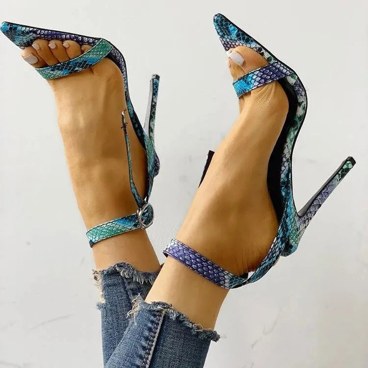 Blue women's high heel shoe with hollow out pattern on PU upper and a silver buckle closure.