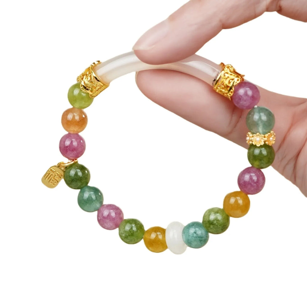 Rainbow colour tourmaline half bracelet for women on a wrist.