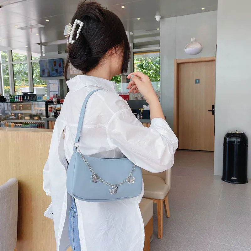 Retro women's chain-strap crossbody bag with butterfly charm in light blue PU leather