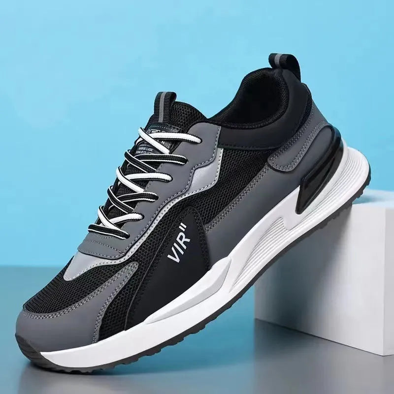 Men's colour block mesh sneakers in black, grey, and white with round toe and flat heel.