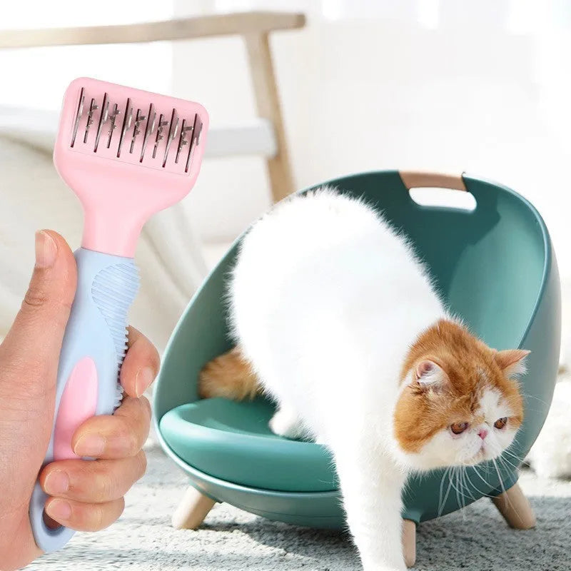 Pink stainless steel dog comb and brush tool with a knot knife edge for pet grooming.