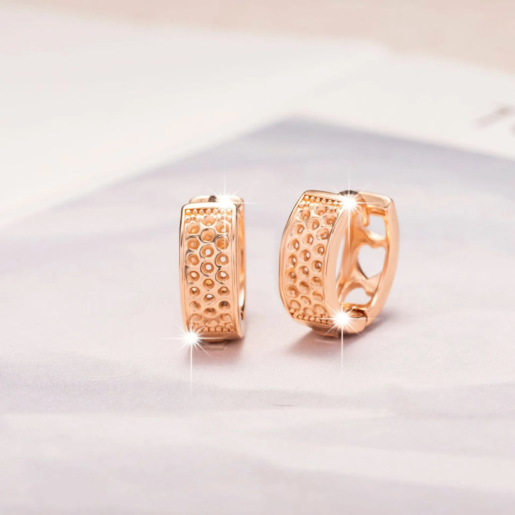 Rose gold hollowed out heart-shaped stud earrings for women, fresh sweet style.