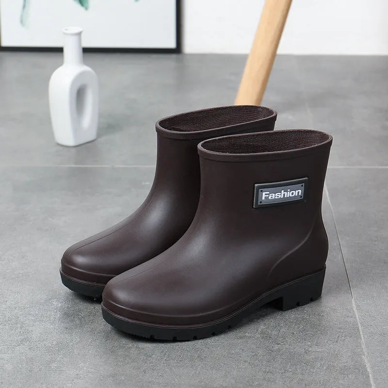 Women's mid-calf PVC rain boots in black with low heel design