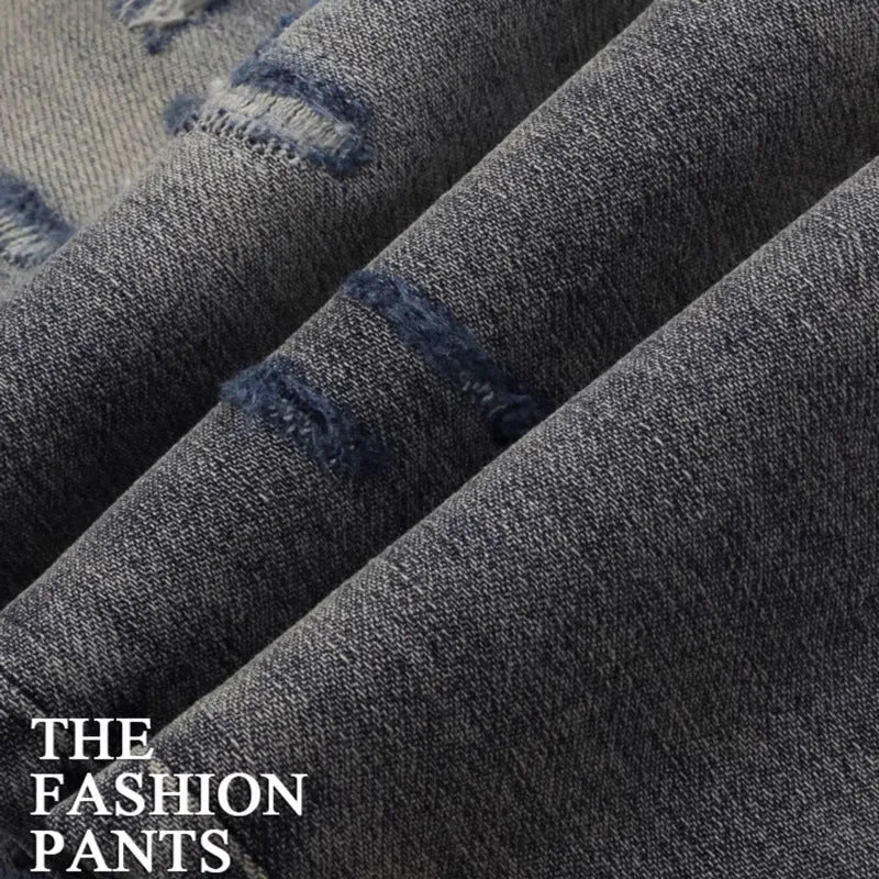 Distressed slim fit jeans with embroidered hole patches in washed-out old colour