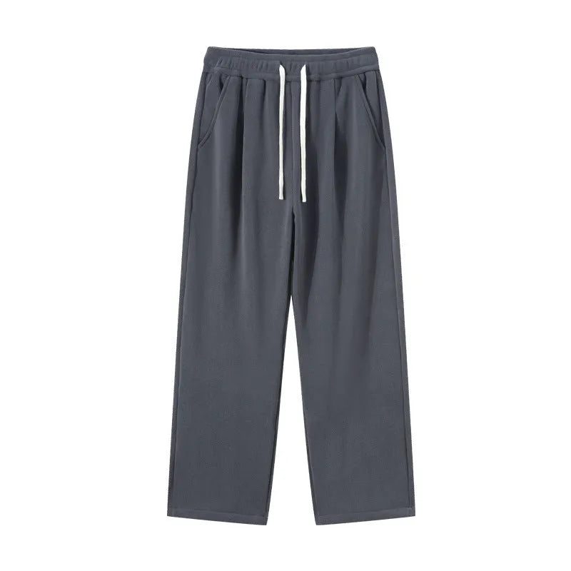 Men's double-sided polar fleece sports trousers in apricot, showing loose fit and drawstring waist.