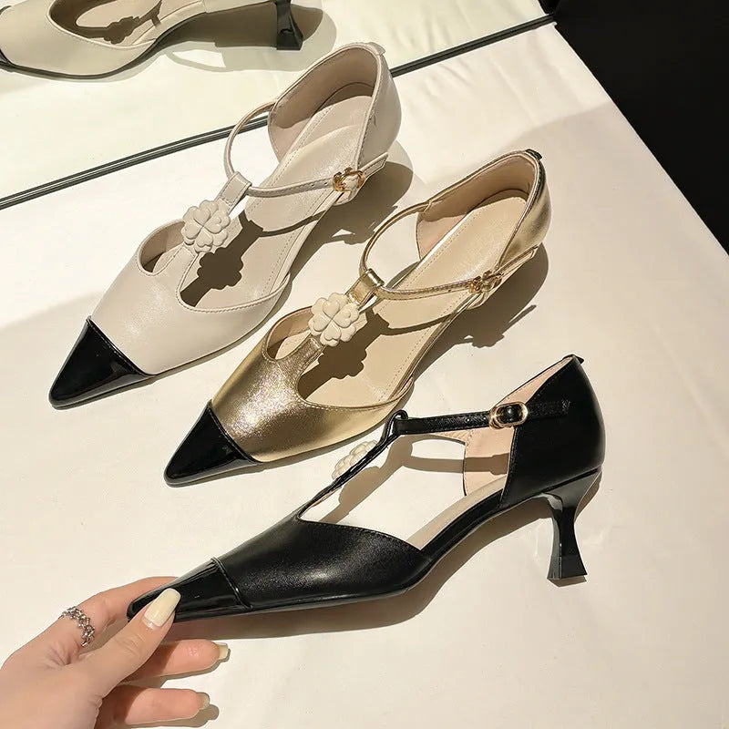 Women's gold stiletto heel shoe with pointed toe, flower buckle, and shallow mouth design on a beef tendon sole.