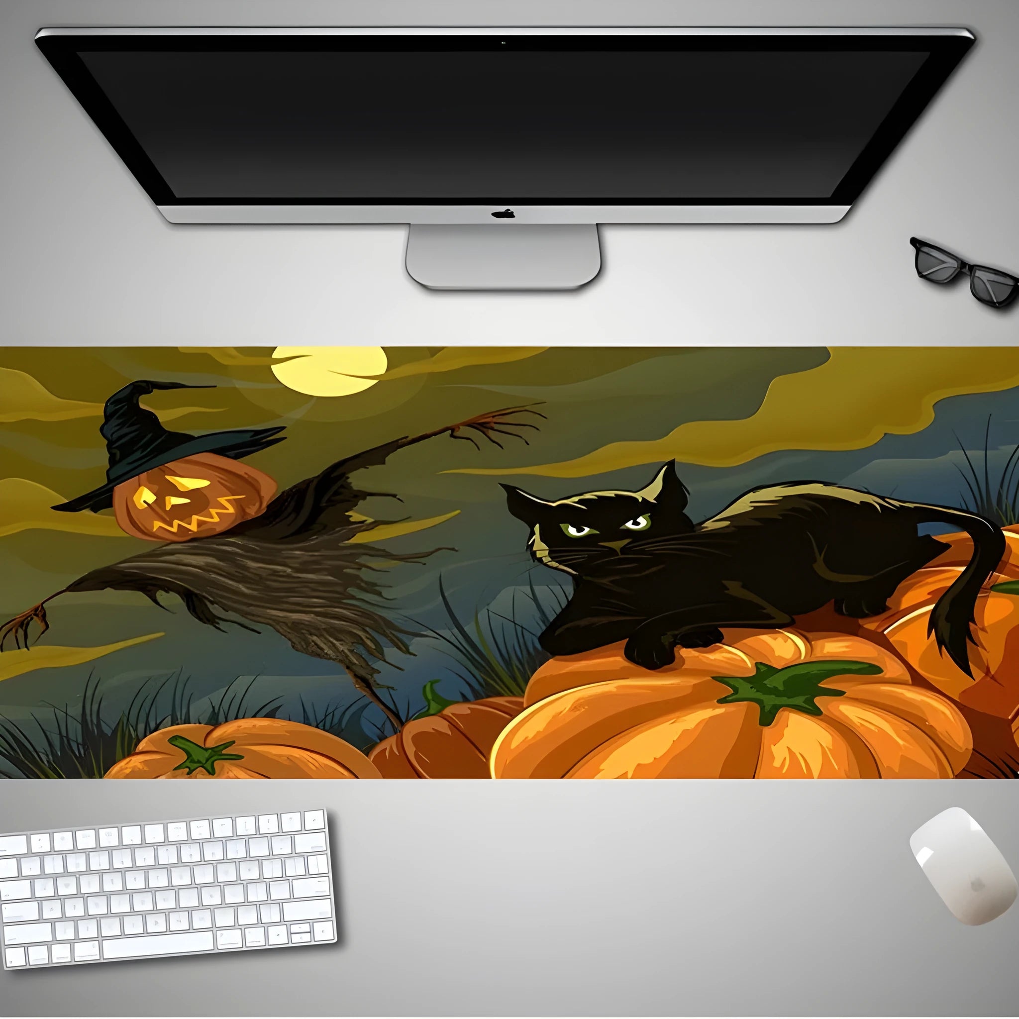 Oversized Halloween graphic cloth mouse pad on a desk, showing non-slip rubber base.