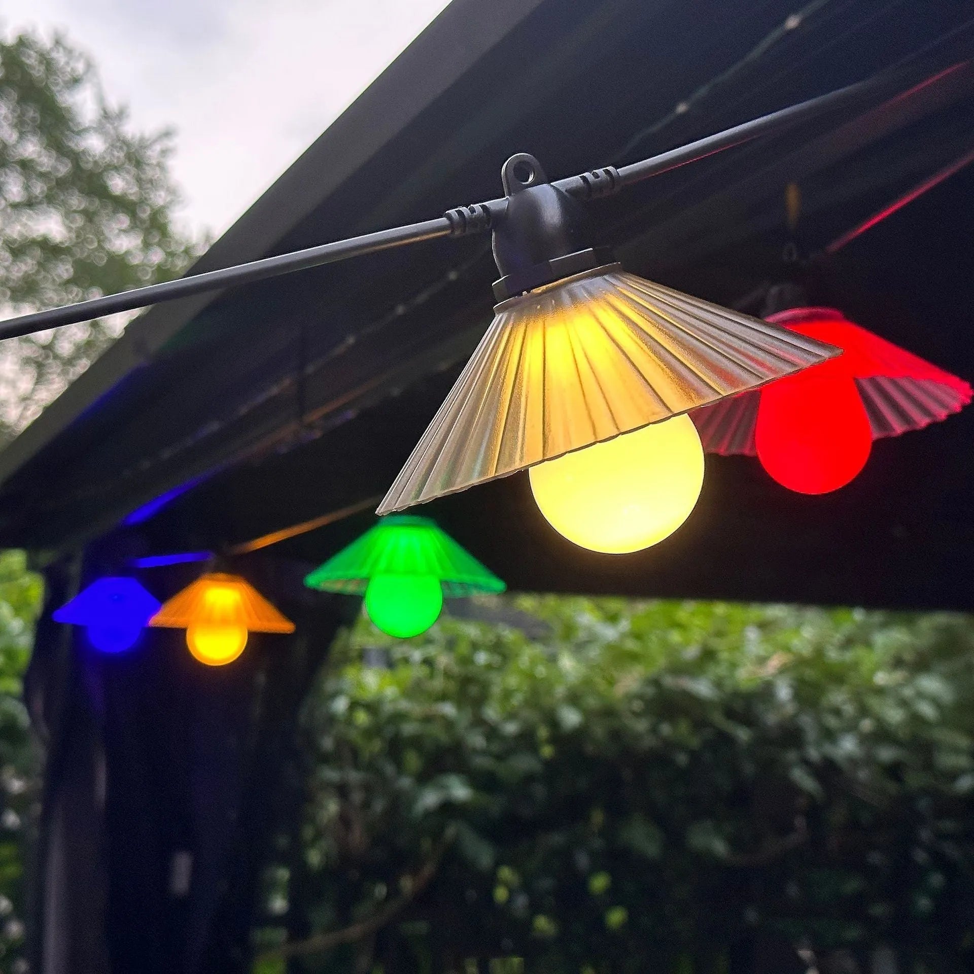 Outdoor LED string lights with flower-shaped bulbs showing warm white and coloured lighting options