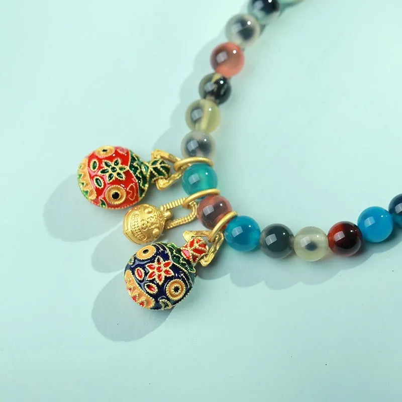 Women's agate bracelet with copper coin snake chain and coloured glaze detailing in geometric bead design