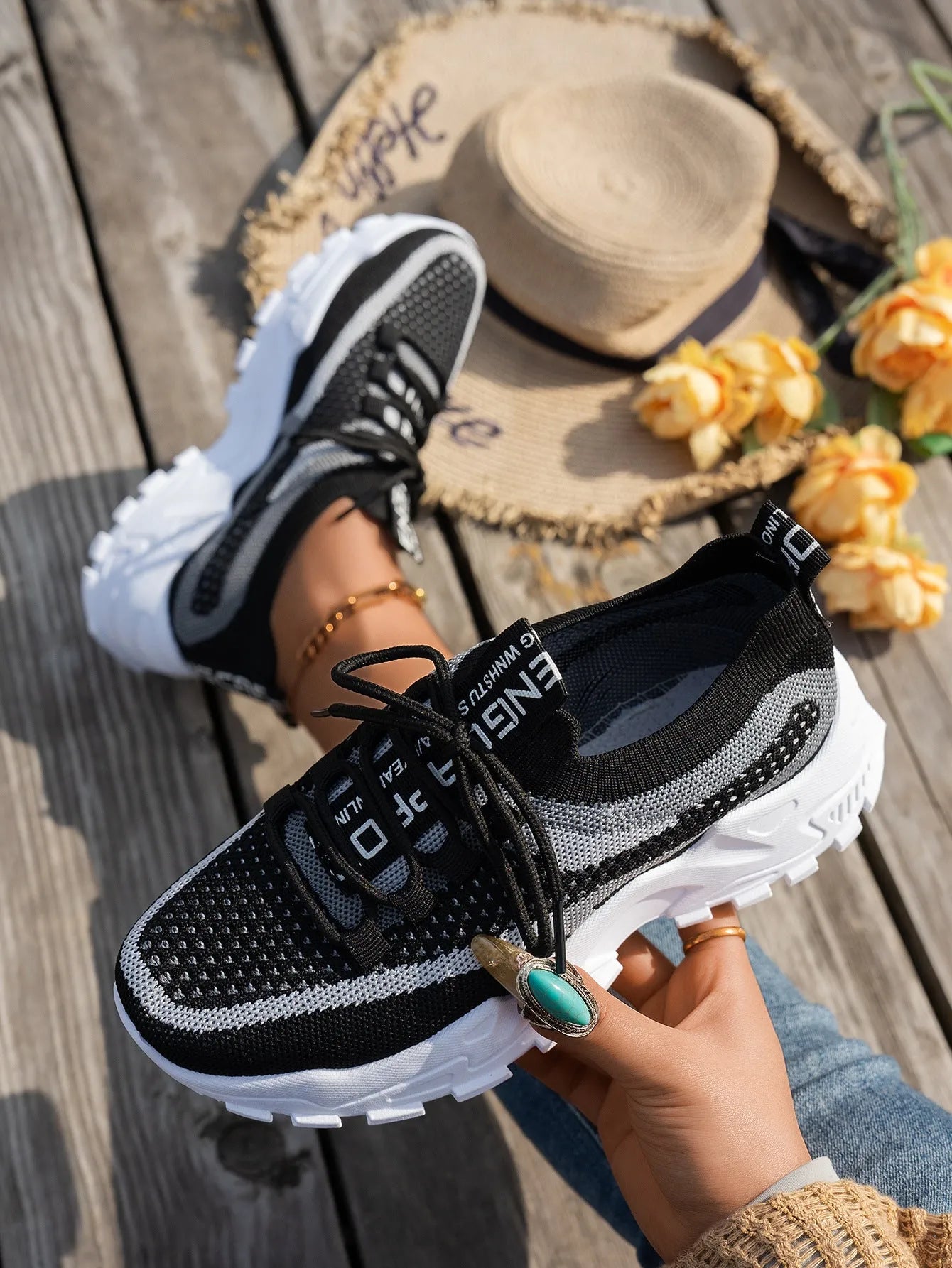 Women's lace-up Flyknit mesh sneakers in a grey colour combination with a round toe and flat rubber sole.