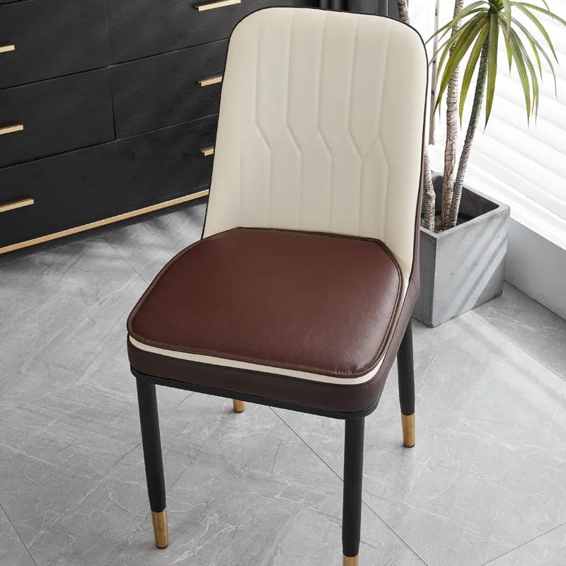 Leather horseshoe-shaped seat cushion in beige colour showing curved design and non-slip underside