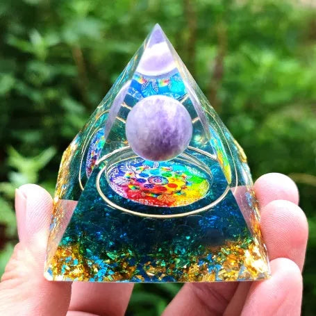 Clear epoxy resin pyramid ornament with embedded blue lapis lazuli crystal gravel, 6cm tall.