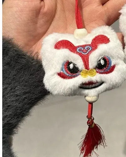 Handmade blue and yellow Chinese style plush lion keychain ornament with star stone decoration.