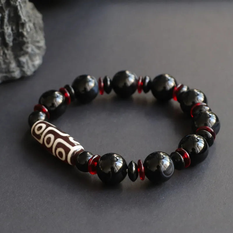 Black agate dzi bead bracelet with chalcedony stones in geometric design