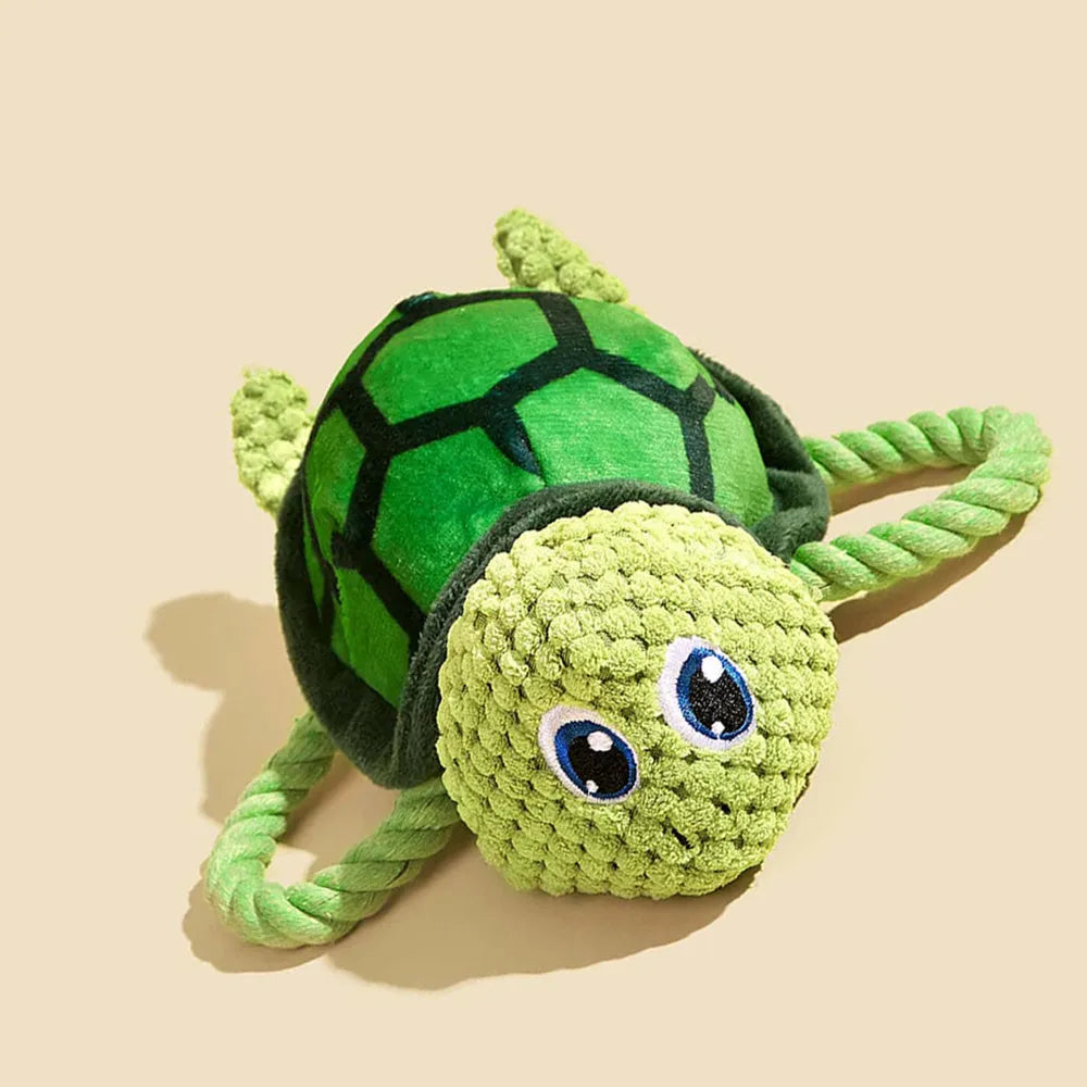 Turtle-shaped dog toy with knotted rope construction and plush stuffing for interactive chewing games