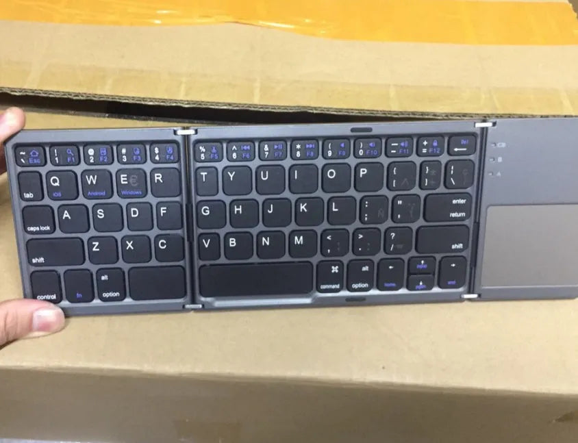 Ultra-thin black tri-fold folding Bluetooth keyboard with touchpad shown in open and closed positions