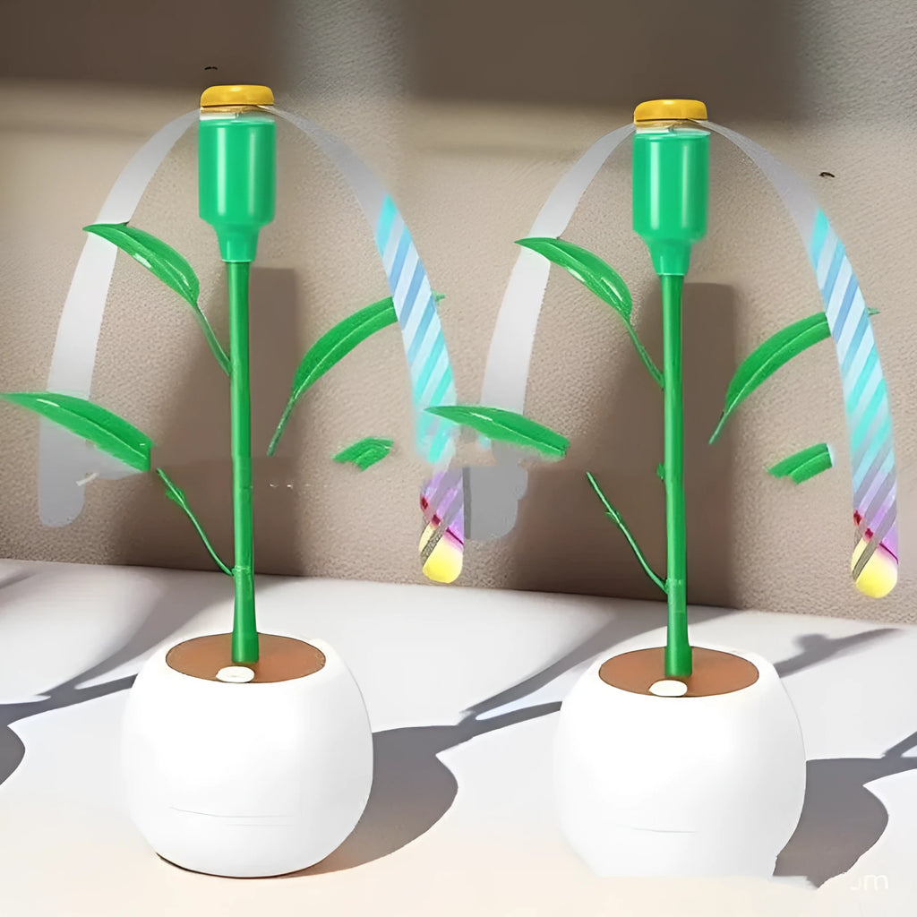 White battery fly repellent fan with curved hose and fruit-shaped design on outdoor table
