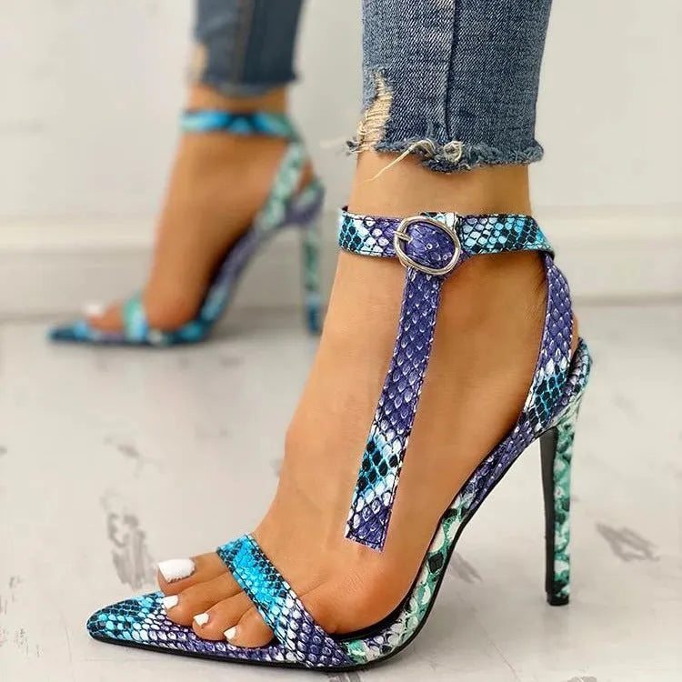 Blue women's high heel shoe with hollow out pattern on PU upper and a silver buckle closure.
