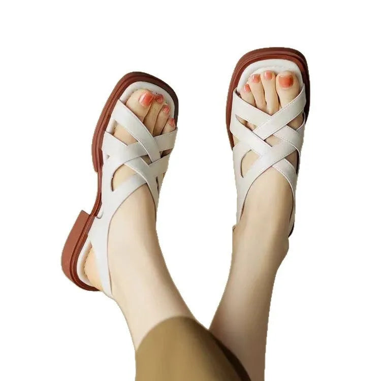 Women's glossy patent leather sandals with square toe and cross ankle strap in black, white, or brown.