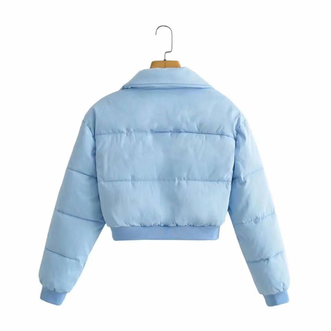 Women's loose-fit polyester jacket in blue, shown with long sleeves and a casual design.