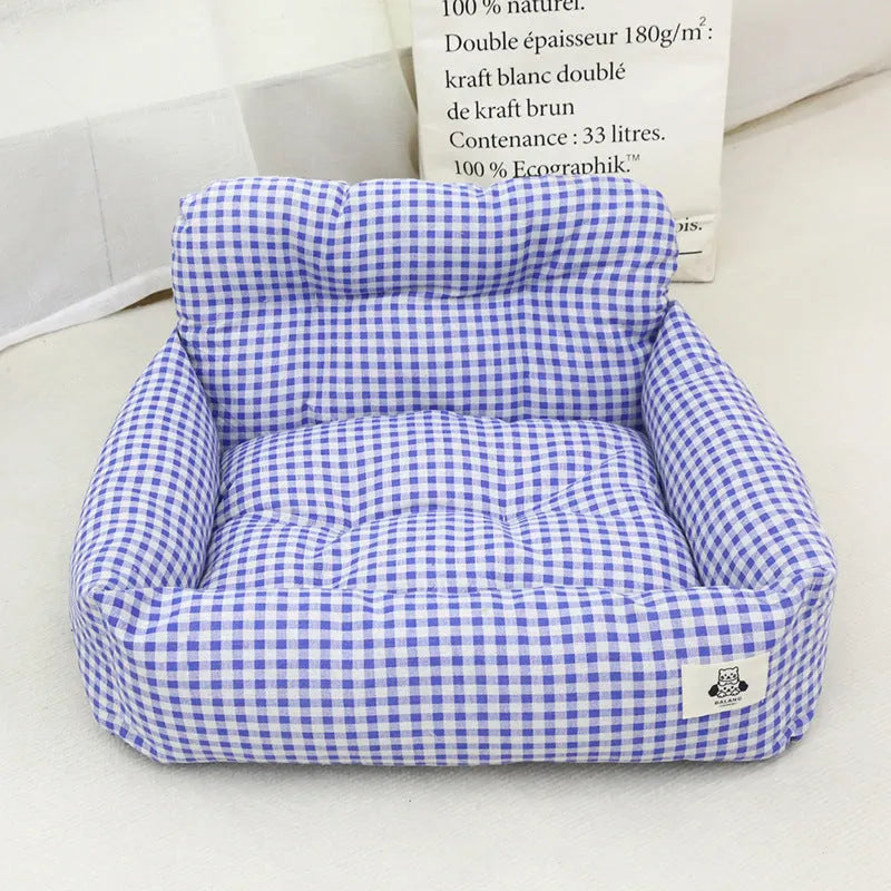 Grey and blue plaid cloth dog car travel nest carriers in two sizes for pet outings.