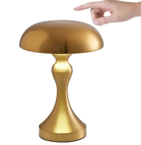 Metallic-finish USB charging desk lamp with touch control on a wooden desk.