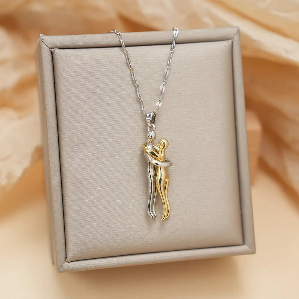 Couple hugging bronze pendant necklace on unisex stainless steel chain with gold lip chain finish, casual style