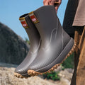 Men's mid tube PVC rain boots in black with non-slip plastic sole, round toe, flat heel