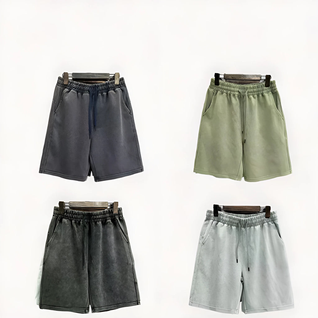Men's solid colour distressed cotton shorts in a loose straight-leg casual fit.