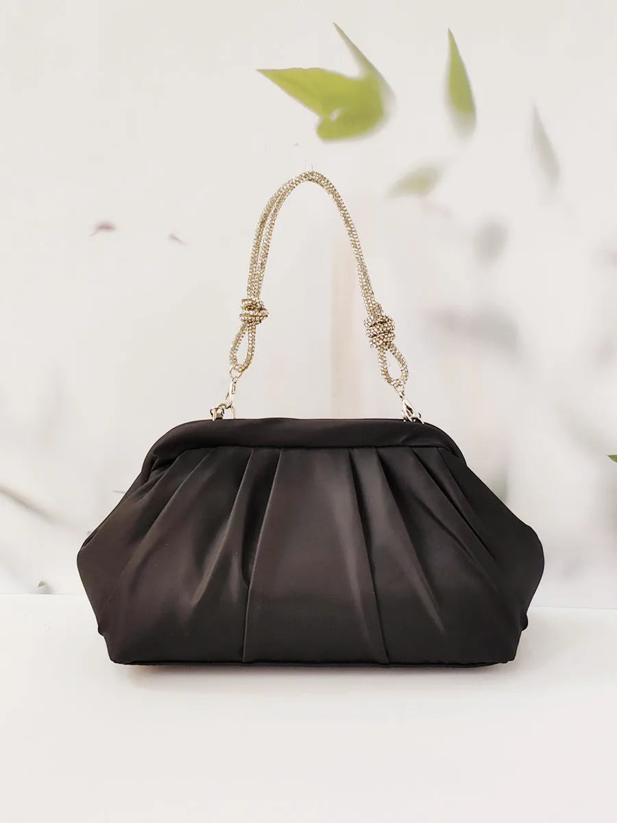 Soft lavender purple women's crossbody bag with chain details and a structured shell shape.