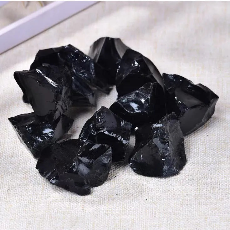 Natural black obsidian rough gravel stones in a pile, size 2-3cm each