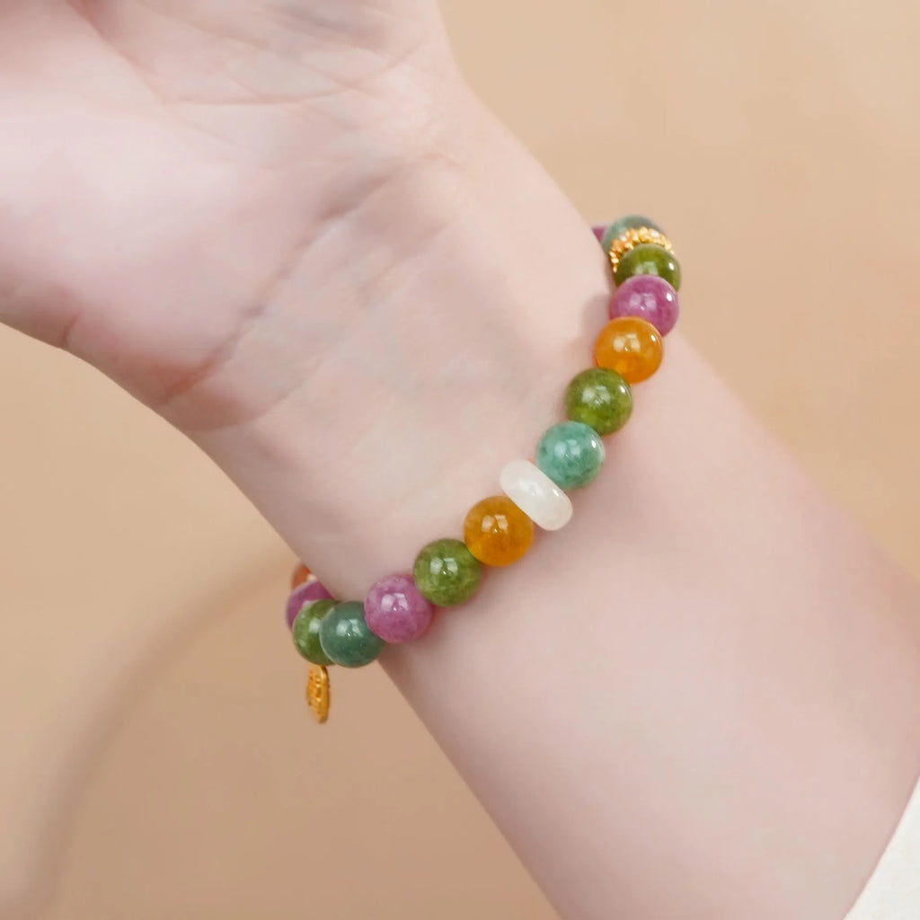 Rainbow colour tourmaline half bracelet for women on a wrist.