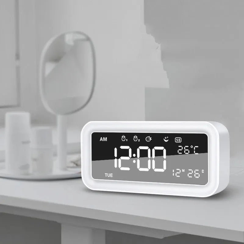 Blue rectangular LED digital alarm clock with multicolour light settings on a wooden surface.