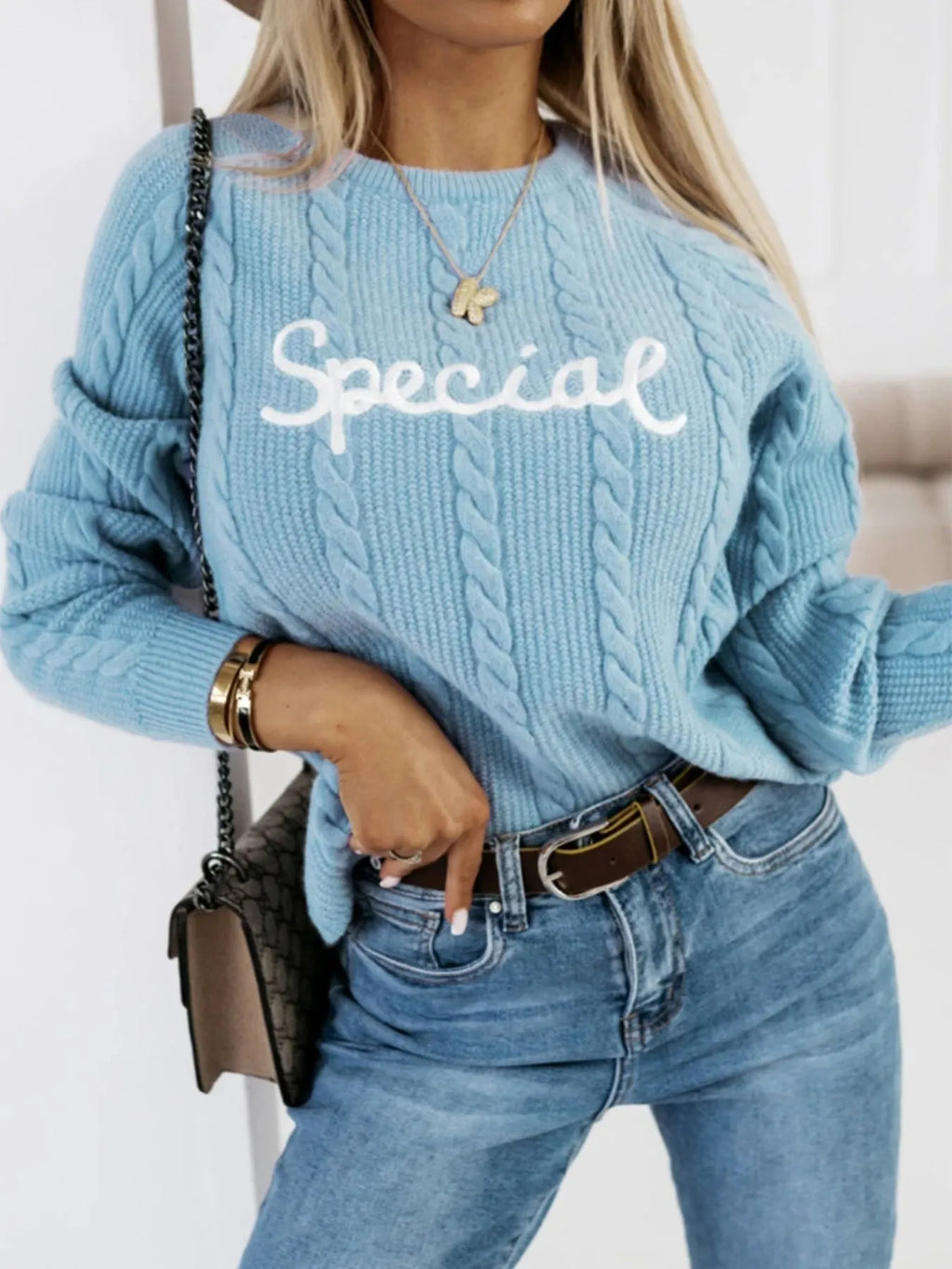 Blue pullover sweater with embroidered letter design on crew neck knitwear