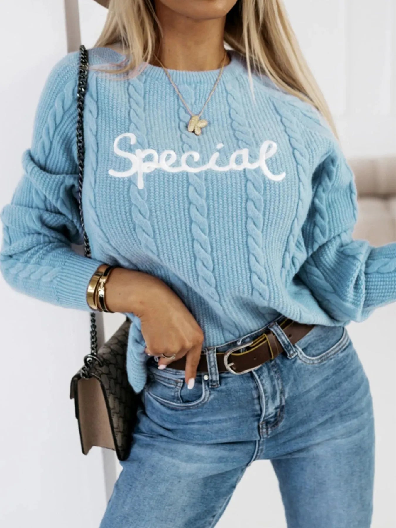 Blue pullover sweater with embroidered letter design on crew neck knitwear