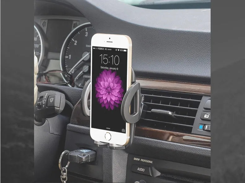 Black universal mobile phone holder attached to a car air conditioning vent.