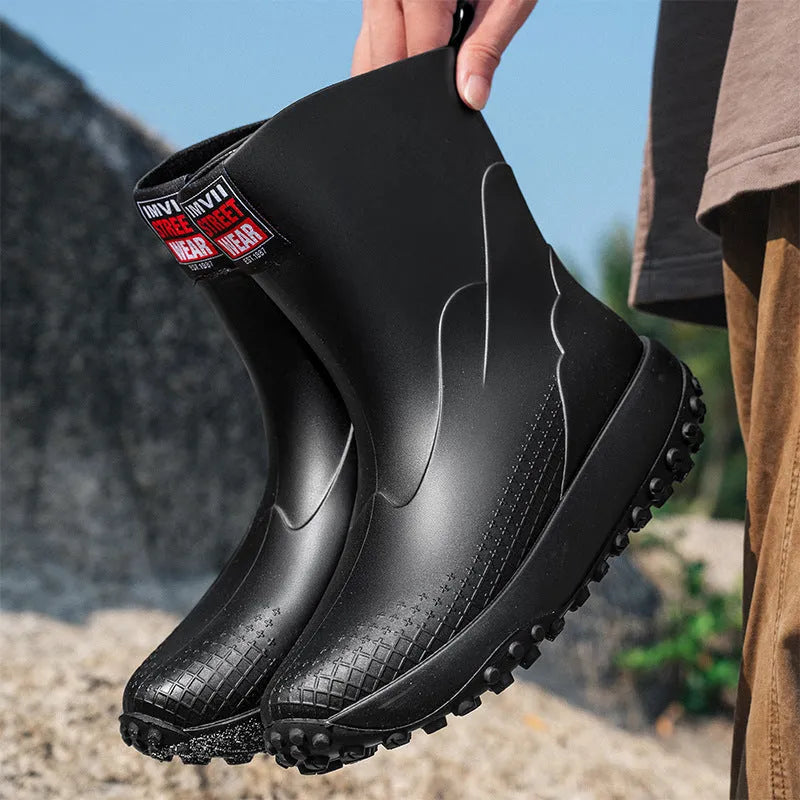 Men's mid tube PVC rain boots in black with non-slip plastic sole, round toe, flat heel