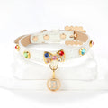 White PU cat collar with diamond alloy bow on a flat surface showing buckle and bow detail