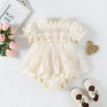 Cotton triangle jumpsuit in apricot with short sleeves and single-breasted front