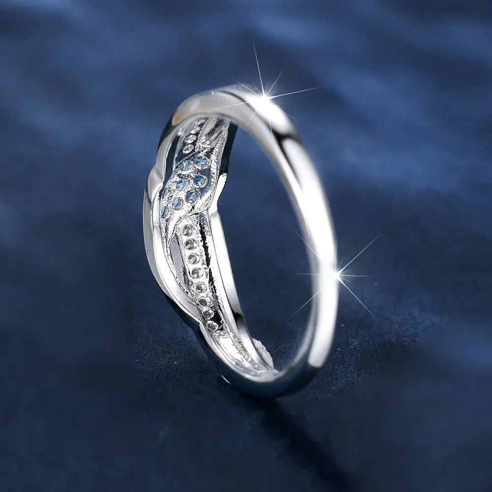 Women's ring with sea blue diamond edge inlay and white diamond leaf accents on white K plated copper band, simple geometric style