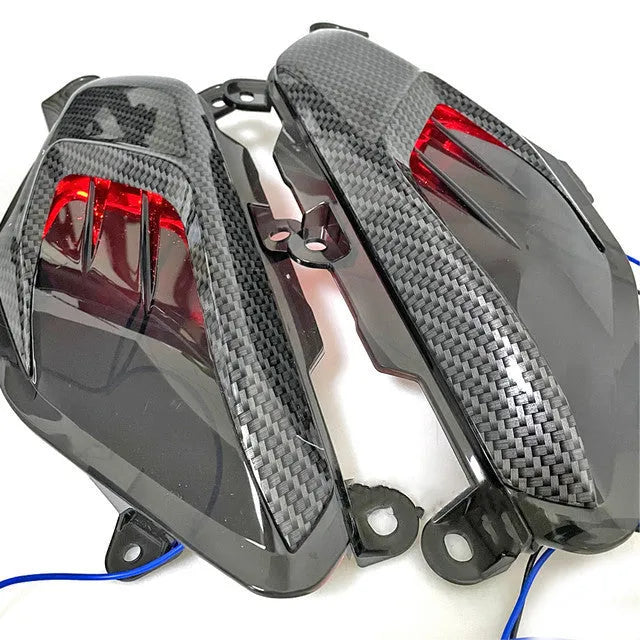 Pair of YAMAHA NMAX carbon fibre LED side lamps with blue or red light options.