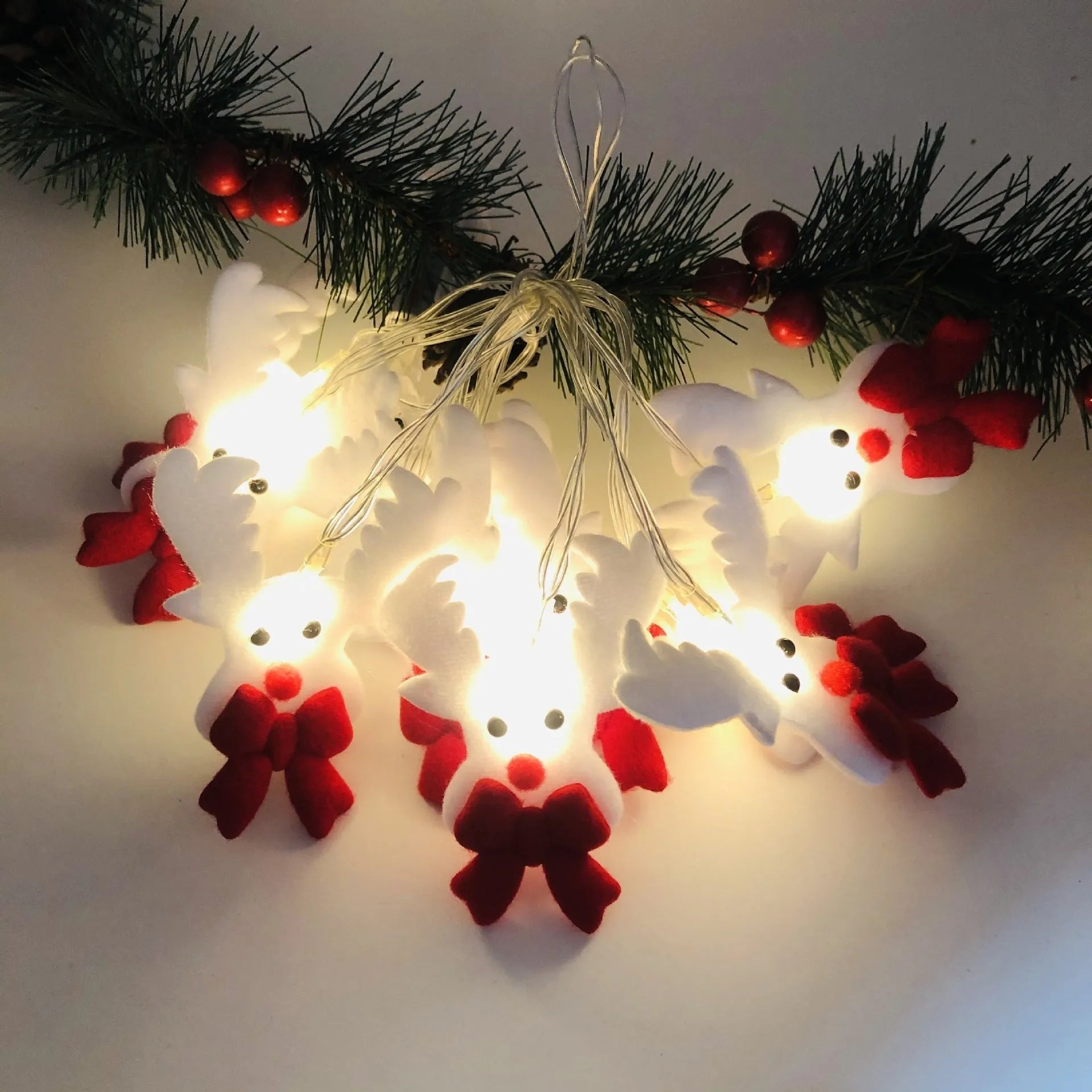 Warm white LED Christmas string lights with Snowman decorative figures on a green garland.