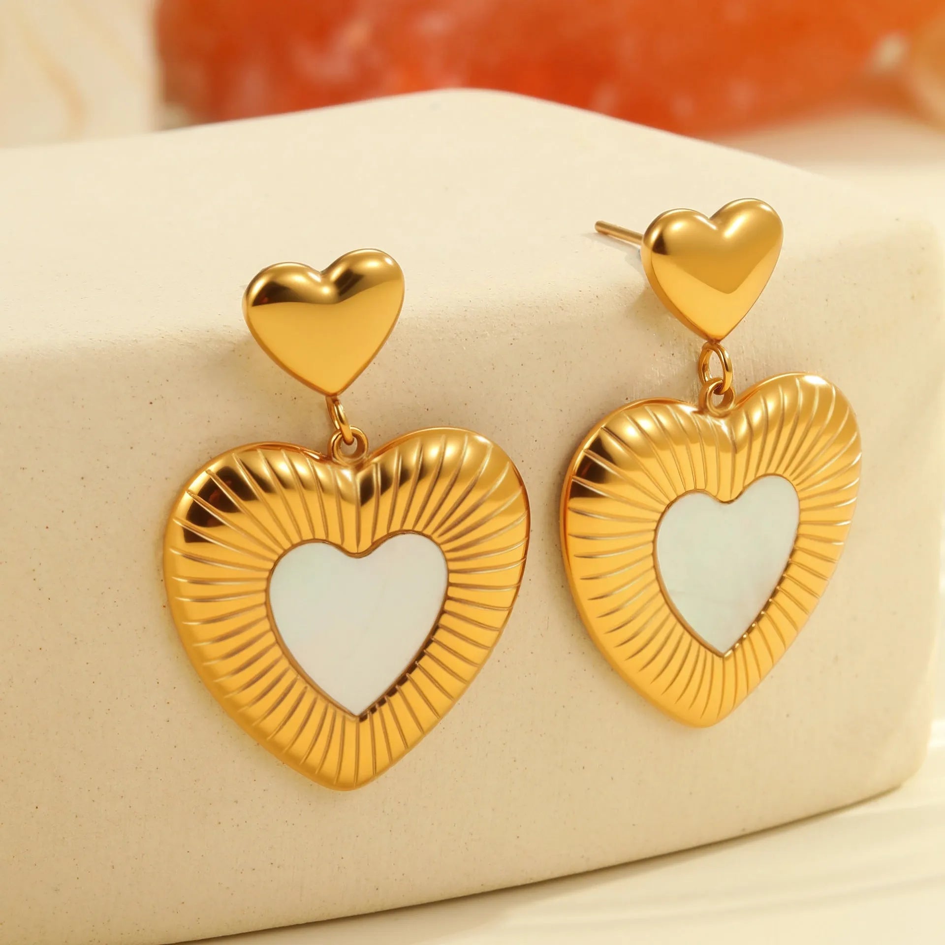 Gold electroplated heart-shaped earrings on stainless steel backing for women's fashion wear