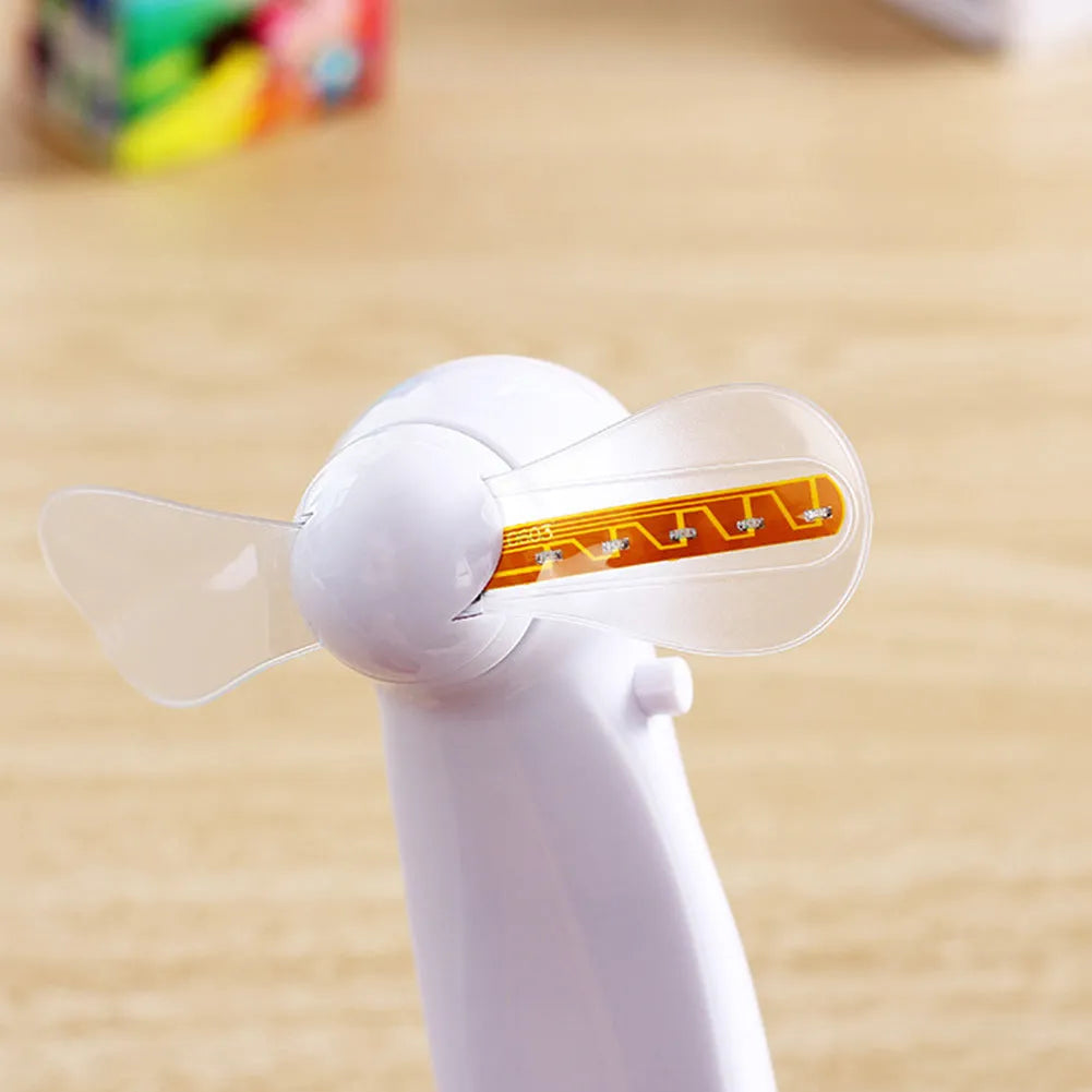 White handheld mini fan with a blue and red LED display showing 'I Love You' and a heart pattern.