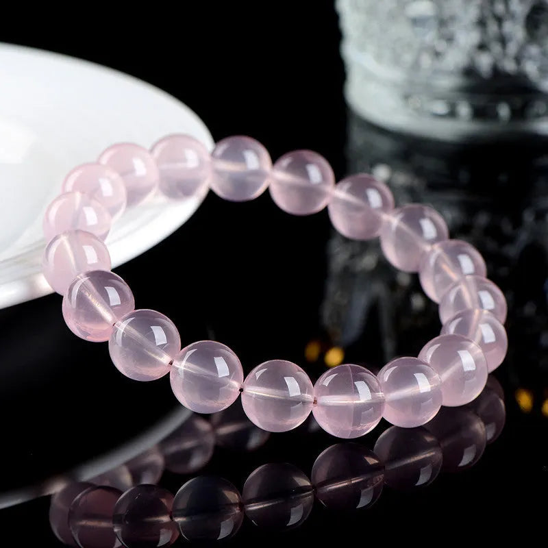 Women's natural starlight crystal round bead bracelet in pink, showing polished finish and single circle bead arrangement.