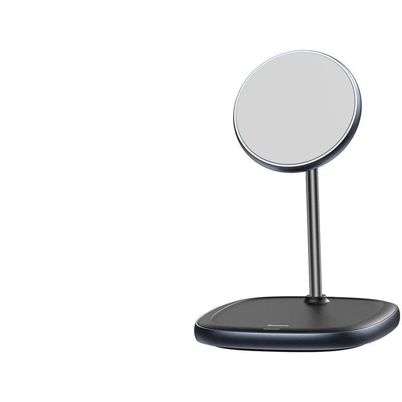 Black magnetic wireless charging stand holding an iPhone 12 Pro on a desk.