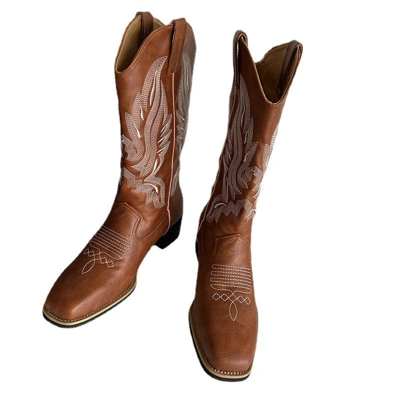 Brown women's Martin boots with embroidered toe cap and mid-calf height.